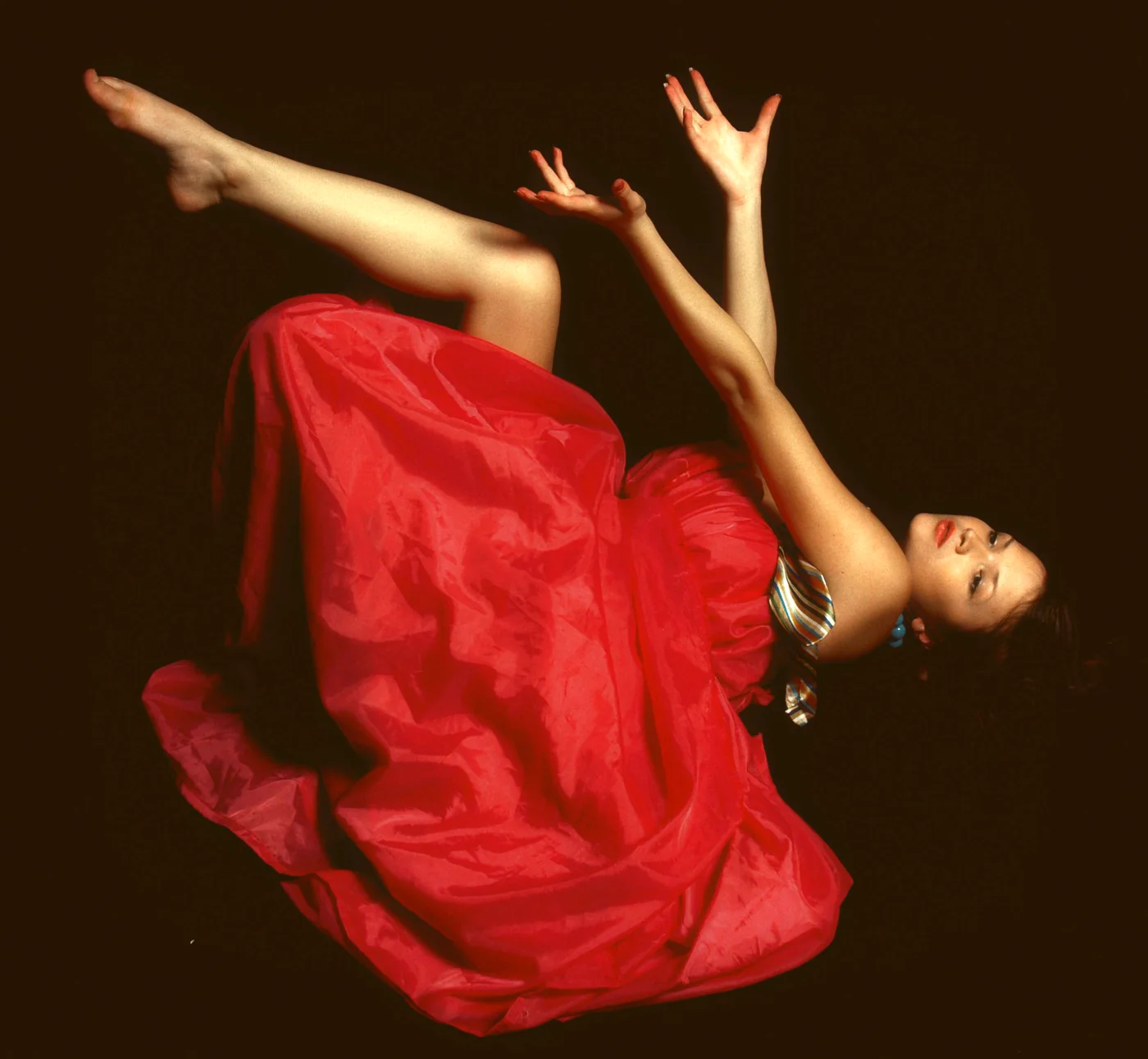 A flamenco dancer in a ruffled dress mid-movement